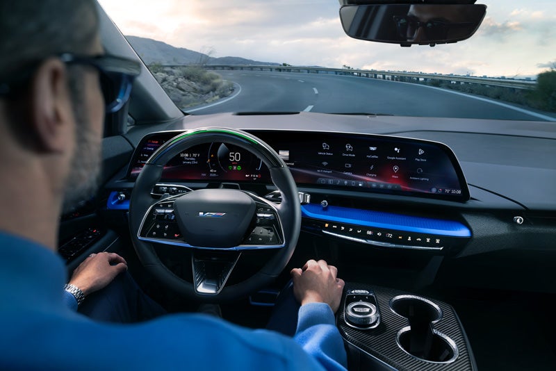 Front View of the 2026 OPTIQ-V Driving Through the Dusk Utilizing its Headlights | Cable Dahmer Cadillac Topeka in Topeka KS